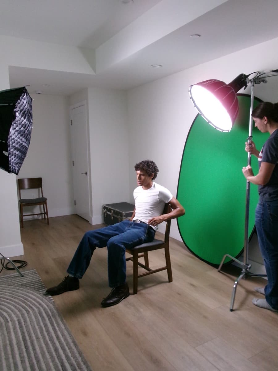 Studio shoot with lighting rig and green backdrop